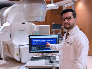 Study senior author Dr. Mohamed Abazeed demonstrates a prototype AI tool that summarizes cancer pathology reports, shown here in a radiation oncology setting.