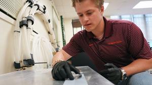Ph.D. student Jack Tapocik sets up ice on an engineered surface in the lab of Jonathan Boreyko.