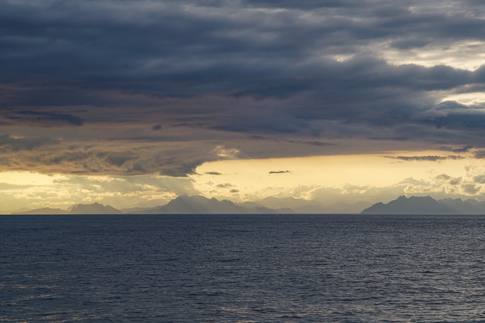 Dramatic clouds and Alaska’s southern coastline frame the Gulf of Alaska during a scientific cruise in summer 2017.